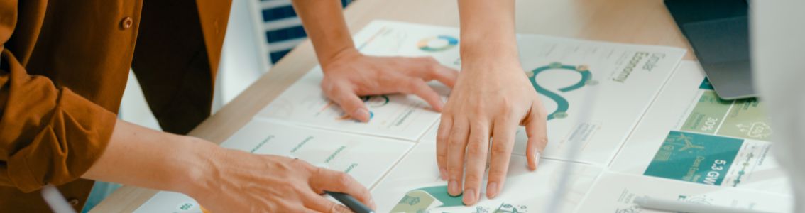 Closeup of team members examine certifications documents