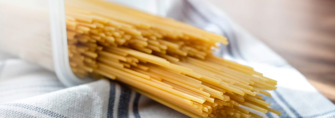  Pile of raw thin spaghetti in plastic container
